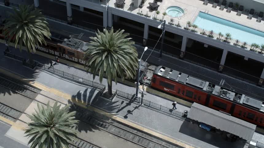 A train moves below near a building
