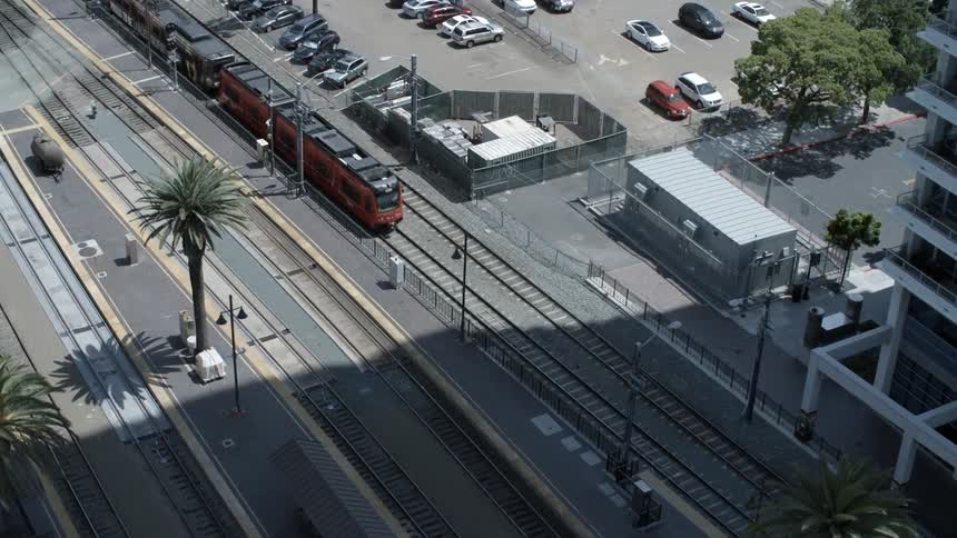 A train moves down a street below