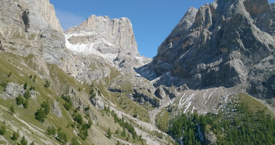 A mountain range with trees at the bottom