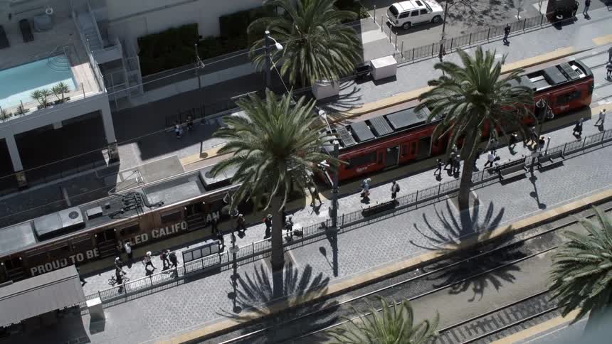 People are walking by a train below
