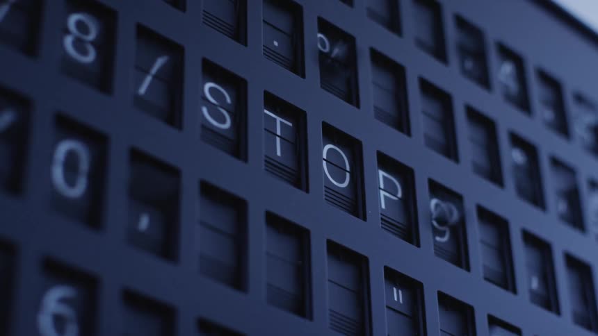 Tiles continuously flip on a board before finally forming the word stop