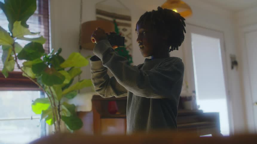 A child is filming a plant