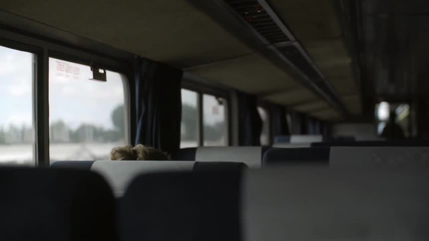 A nearly empty bus drives down the road