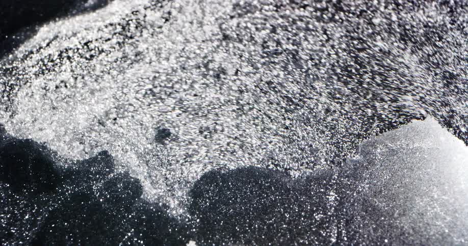 Water flows quickly breaking up and shifting surface ice
