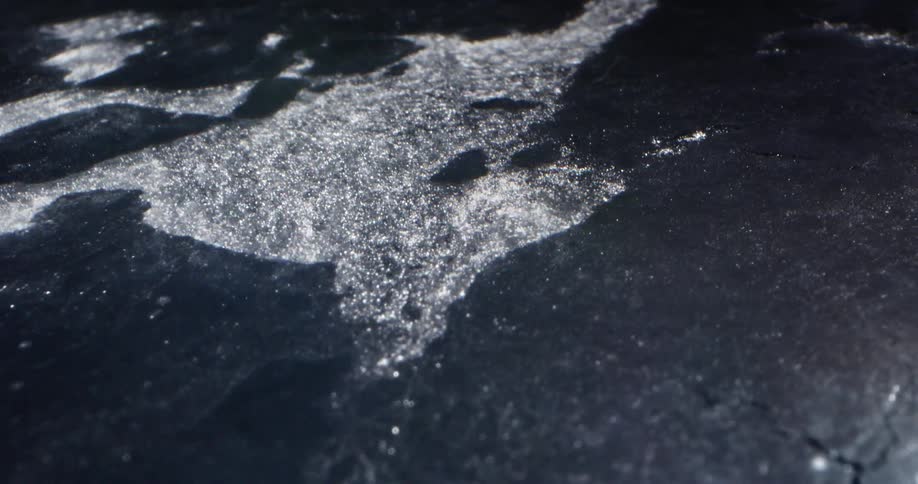 Spilled water splashes on a flat surface