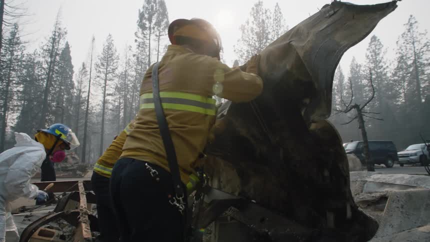 A group of firefighters lifting materials