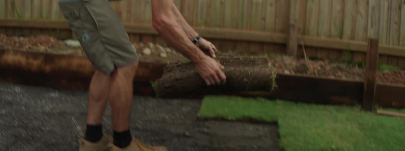 A man is outdoors and is gardening during spring