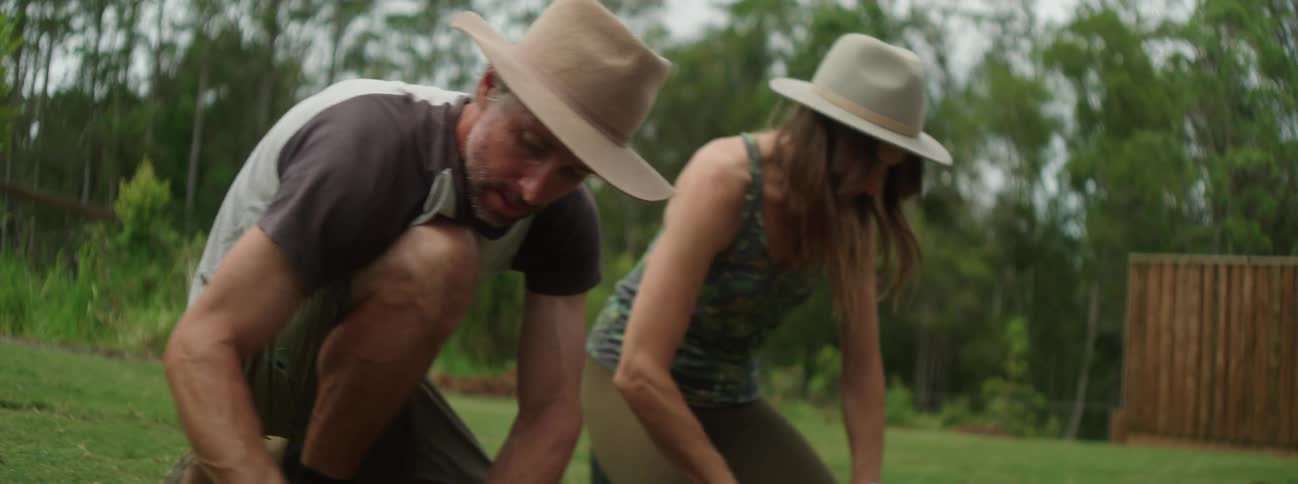 A group of people are outdoors and gardening