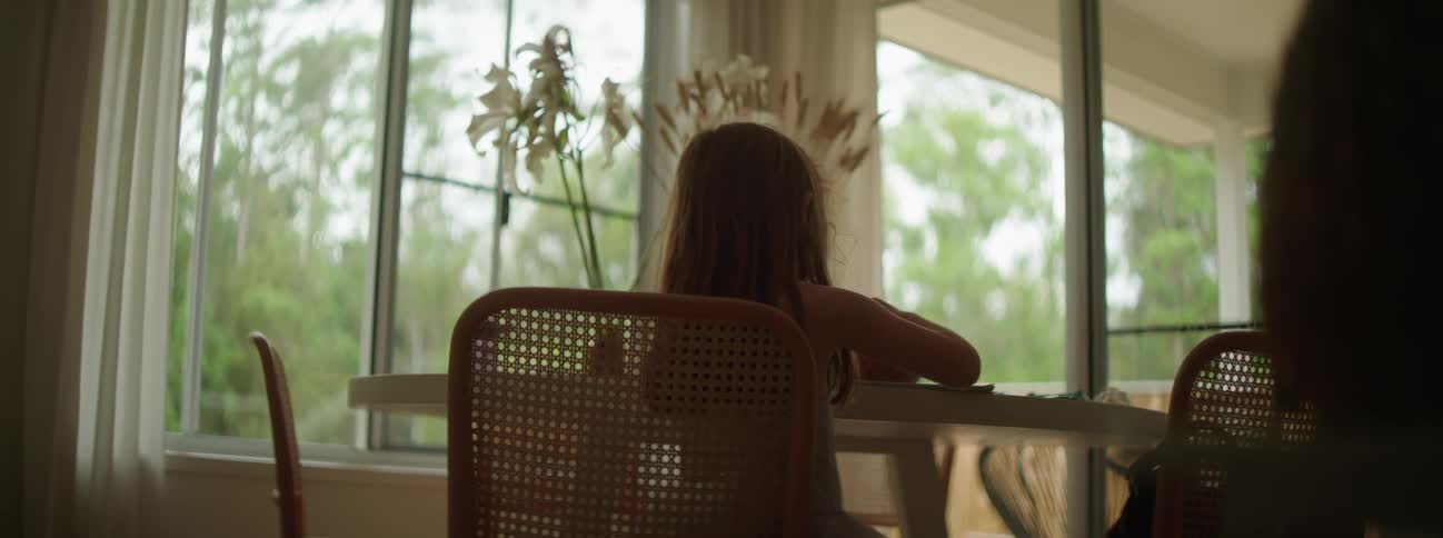 A girl is drawing at the table