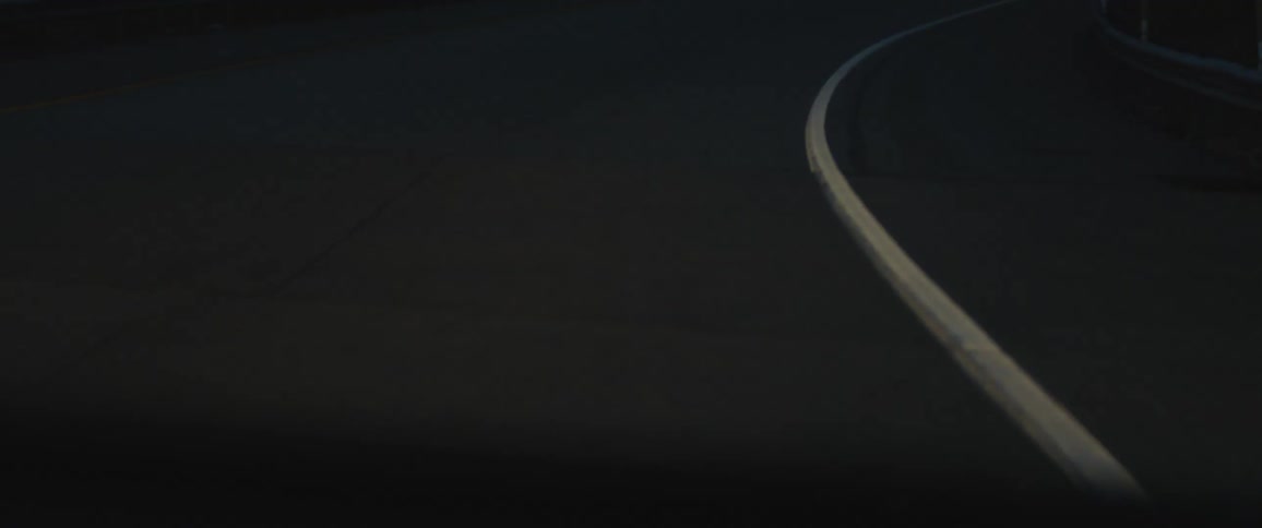 A car drives on the highway at night