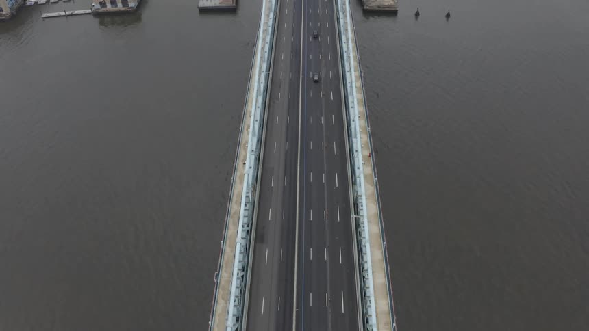 Cars travel on the bridge towards the city