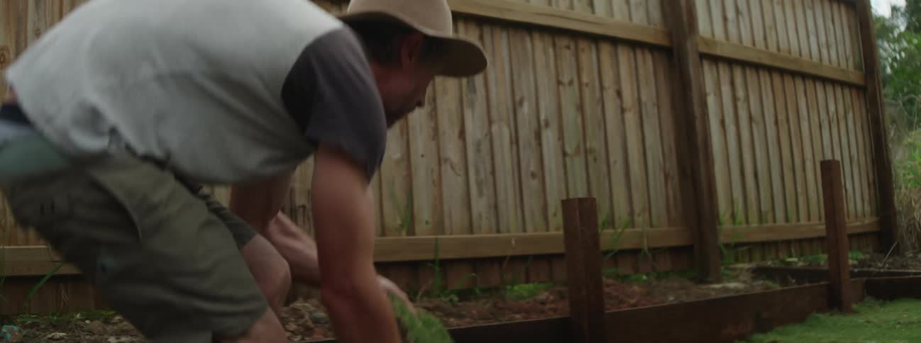 A man is outdoors and is gardening during spring