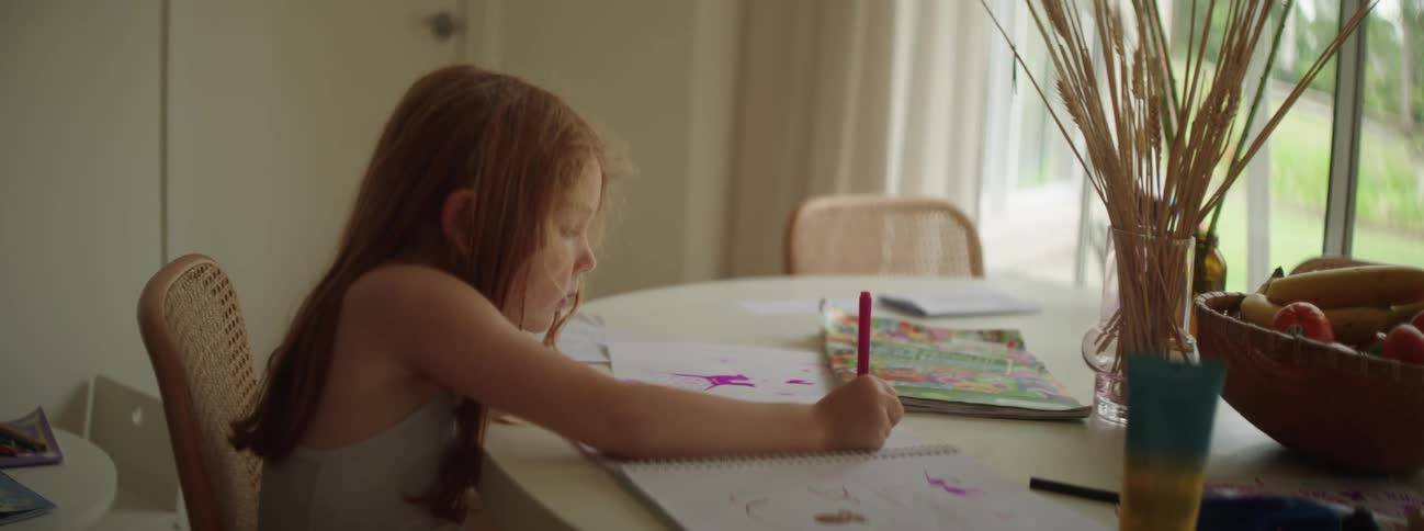A child is coloring at the table