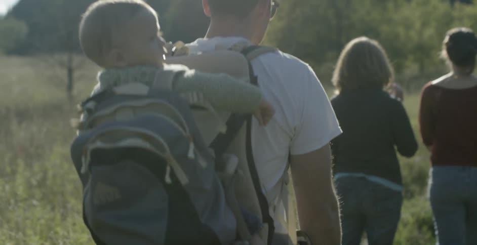 A family hikes near a forest