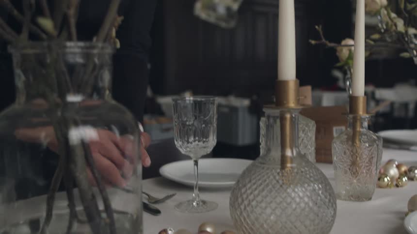 Woman decorates dining tables in restaurant