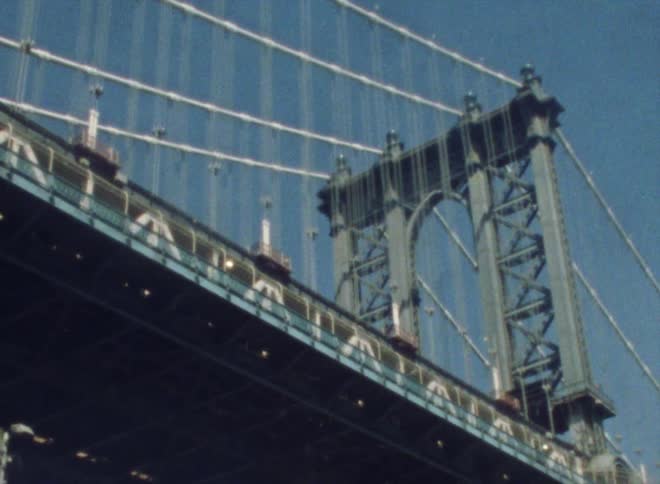 A bridge zoomed in on while someone walks across it