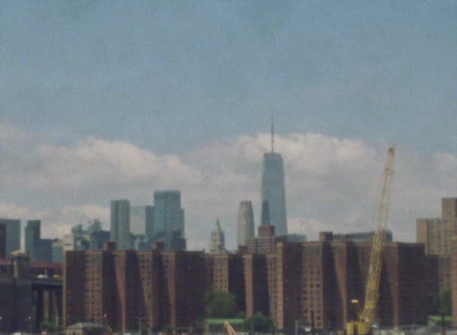 A city skyline with businesses buildings skyscrapers and a yellow crane