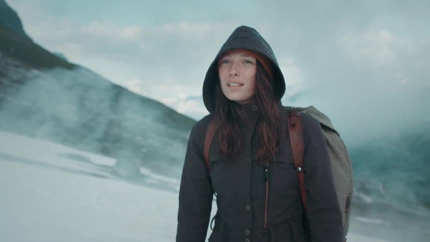 A woman is walking outdoors in an arctic area