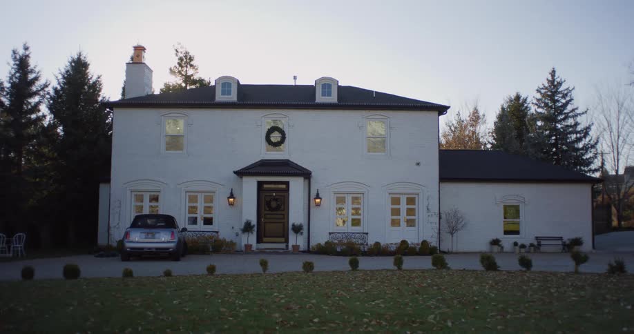 Exterior view of villa house with yard at dusk in the countyside