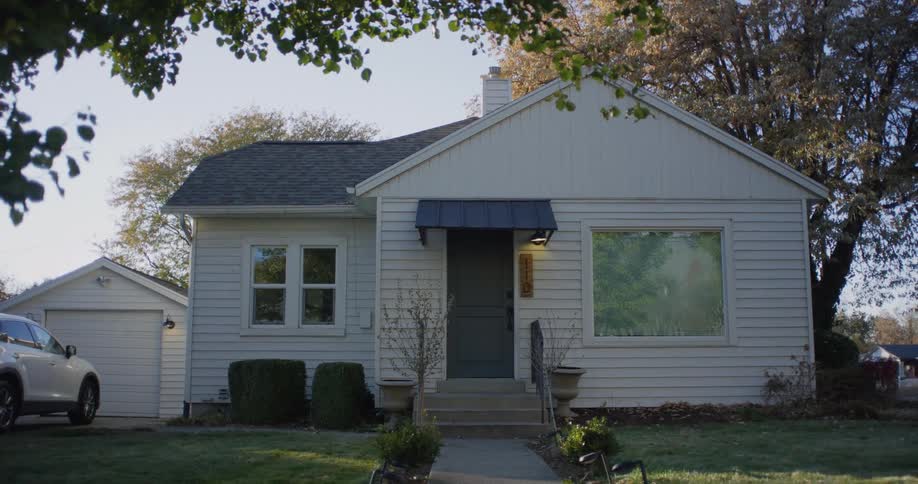 A single story home has a green lawn