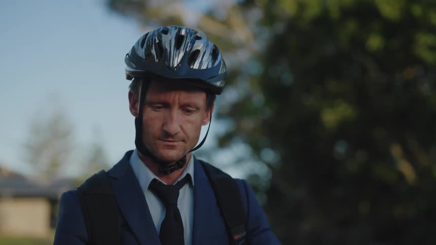 A man talks on the phone before taking off on a ride