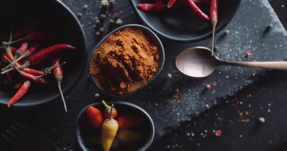 Spices and vegetables are displayed on a table