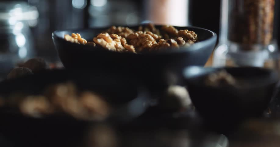 Walnuts are all over the counter and in the bowl