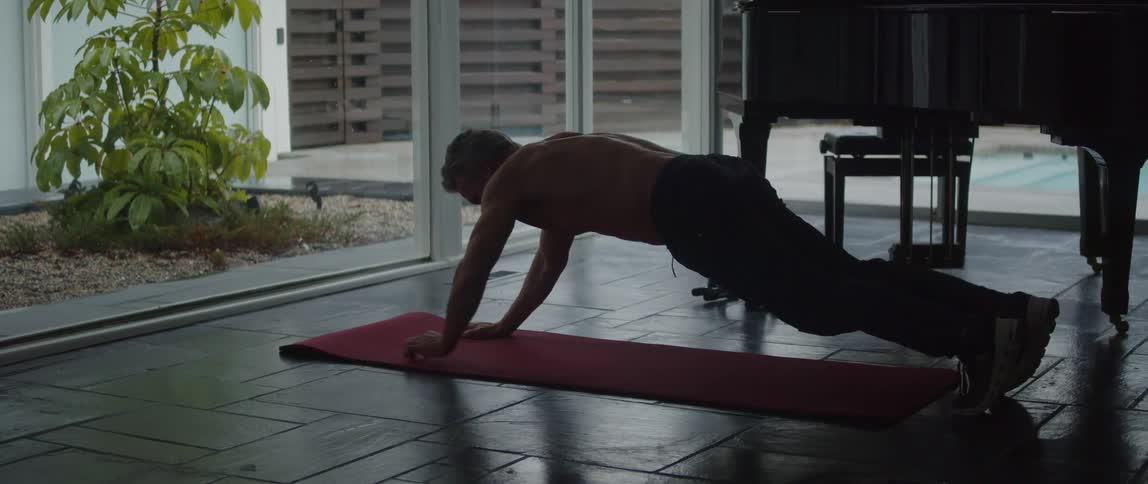 A man is doing yoga indoors