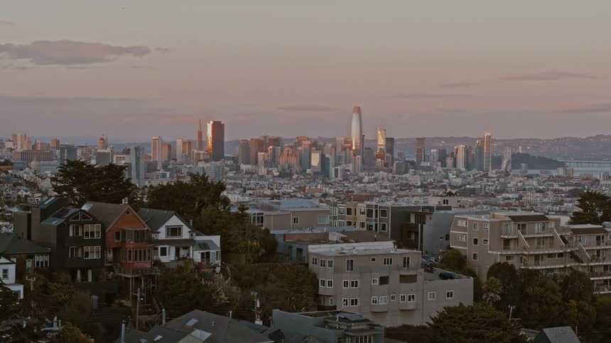 Aerial view of a downtown city at dusk is displayed