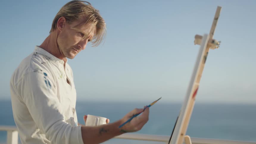 A man painting on a canvas