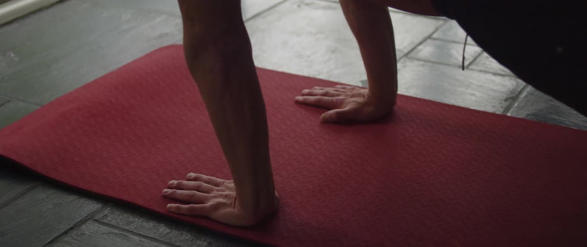 A man is doing yoga at home