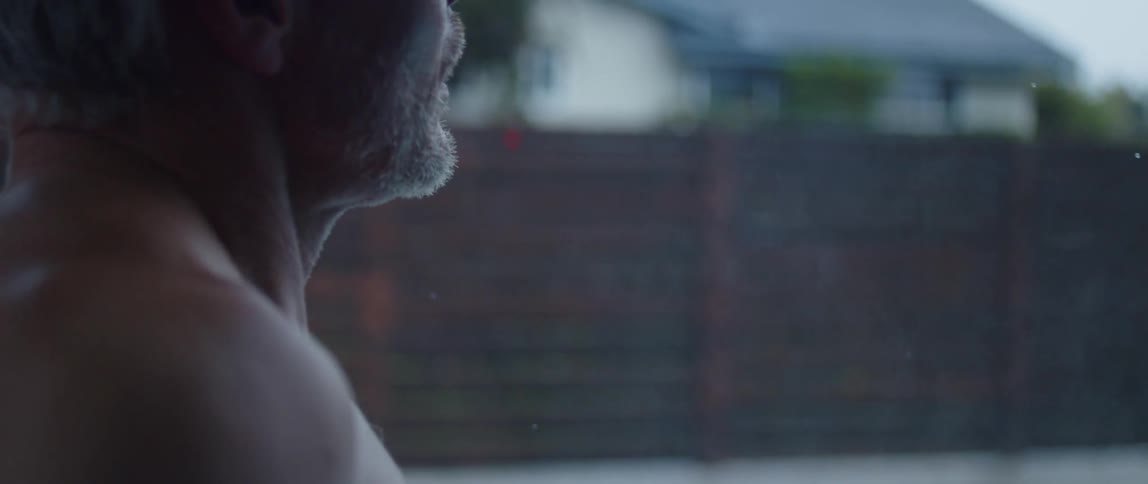 A man looks out of his window