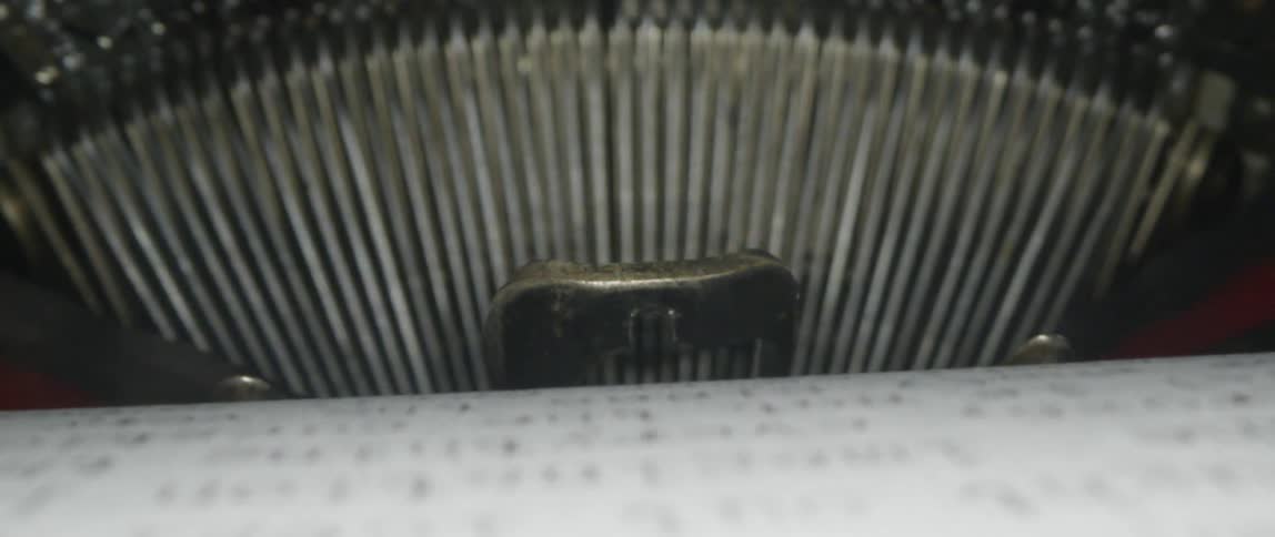 A document is typed on a vintage typewriter