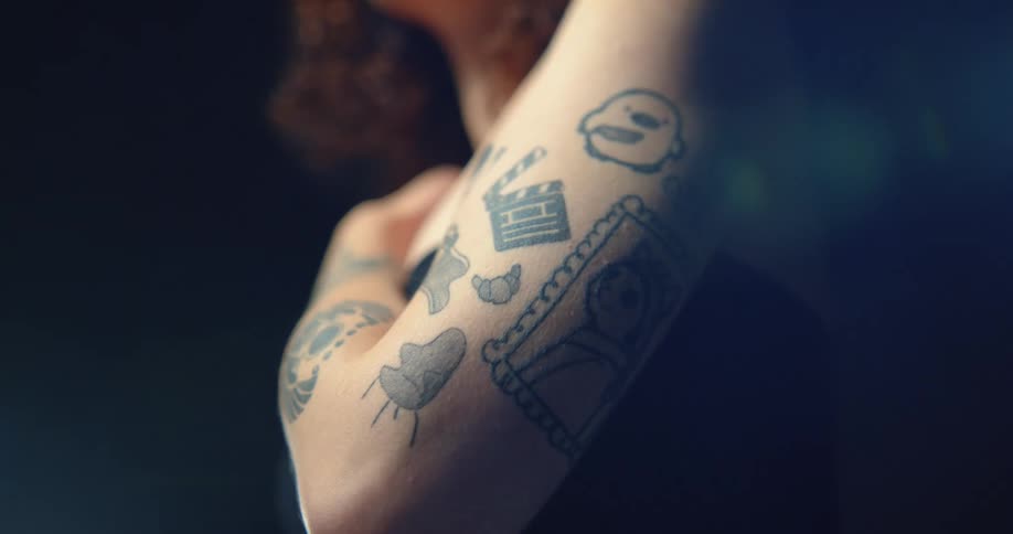 Female models arm with tattoos in studio