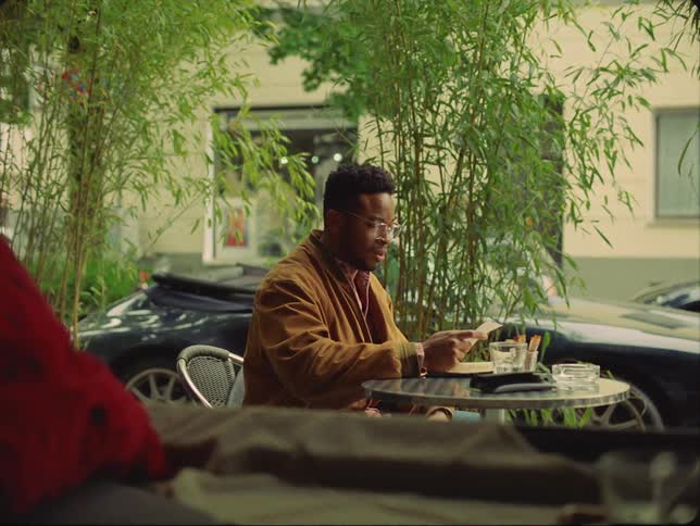 A man is sitting at a restaurant table by himself