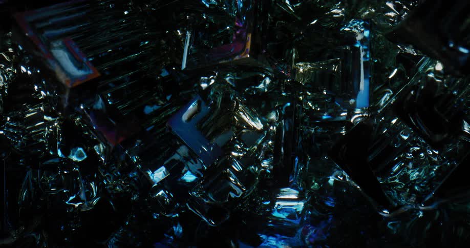 Increasing light reflects from the angular surfaces of bismuth crystals