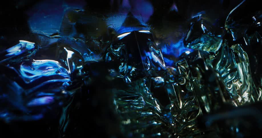 A blue gemstone shines under a light