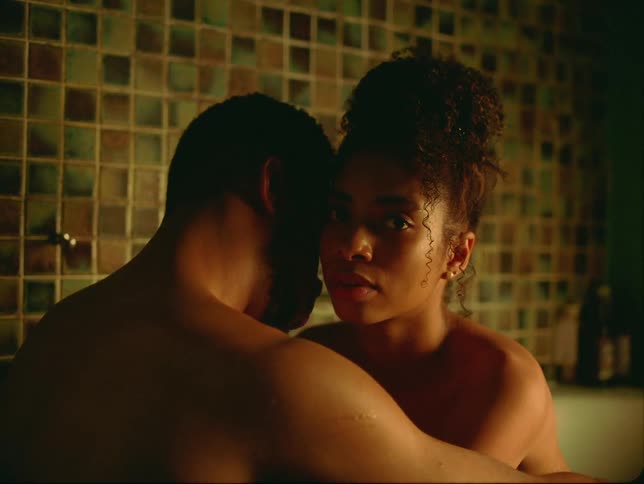 A black couple hugging in a bathtub