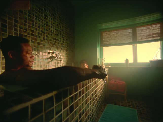A man takes notes while sitting in his bathtub