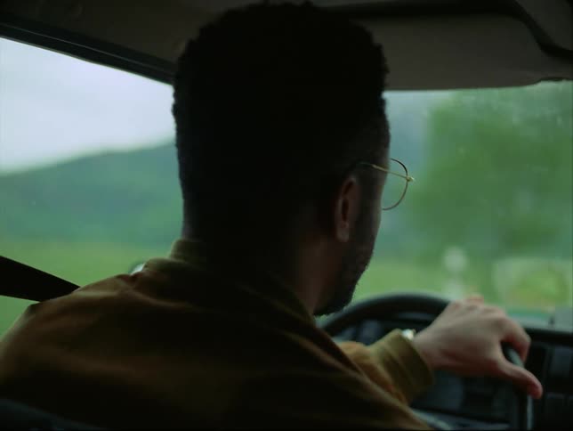 A man keeps looking down while driving