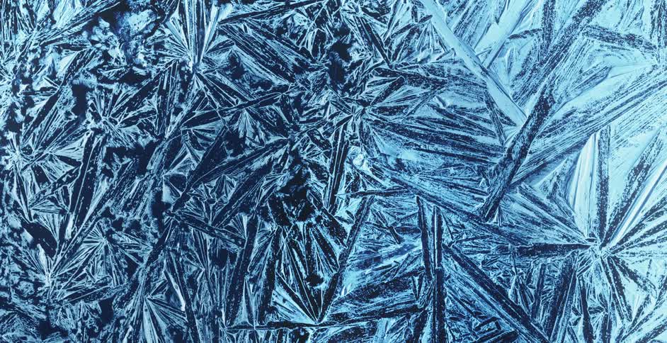 A blue light shines behind crystalized ice