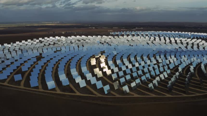 A large solar farm forms a circular shape