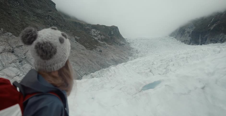 A woman looking at a canyon full of ice