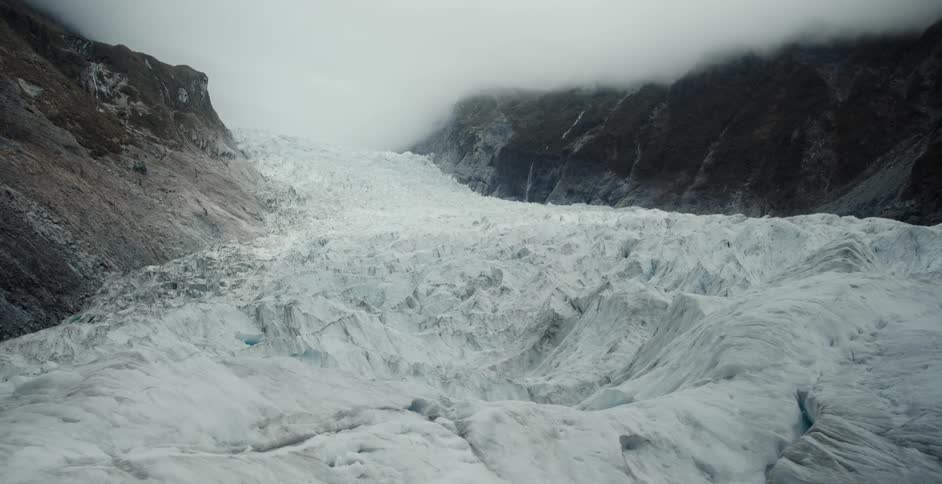 Reveal of the rugged surface of a glacier on a valley between mountains