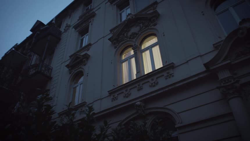 Lights turn on on the window of a building at night