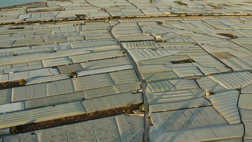 Large greenhouses on the ground fit together like puzzle pieces
