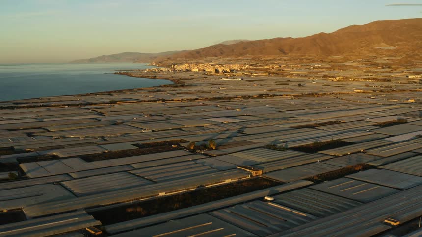 Greenhouses surround this tiny agricultural town on the sea shore