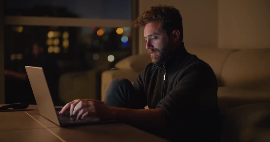 A man using a laptop in a room
