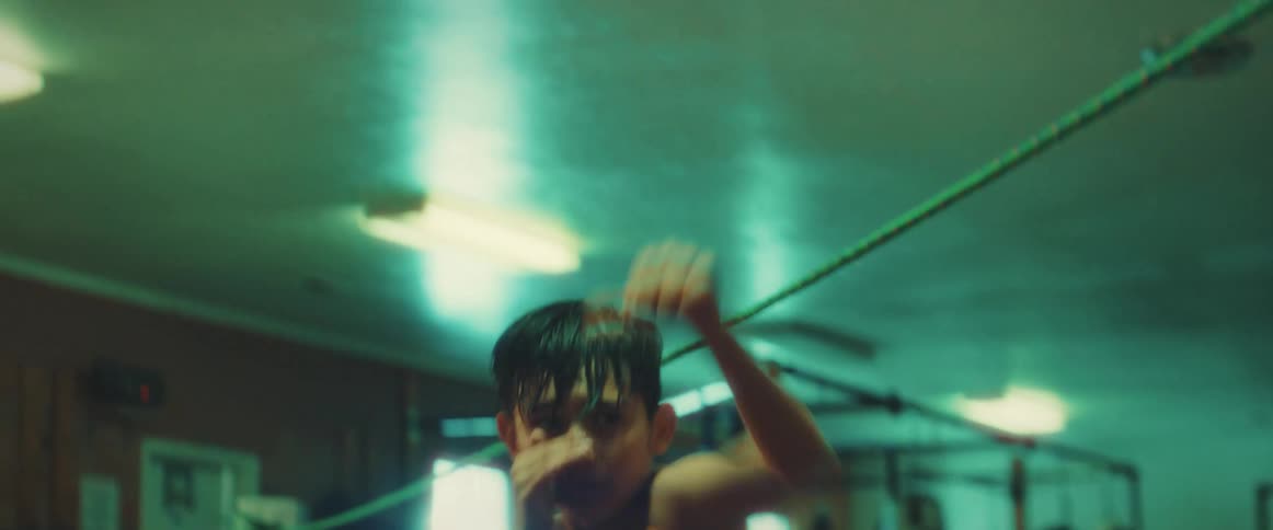 A boy is shadowboxing in the ring