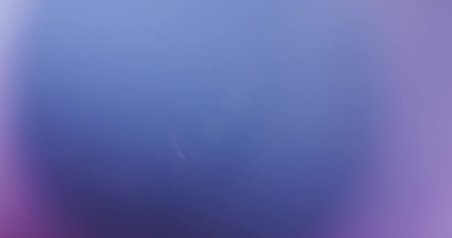 Bright magenta and purple lights flicker while moving on the interior of a cylinder